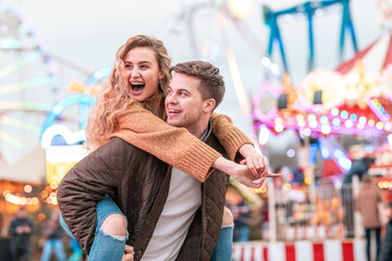 Happy couple having fun at amusement park in London - 539861160