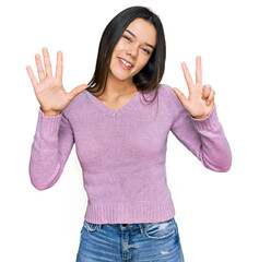 Young hispanic girl wearing casual clothes showing and pointing up with fingers number eight while smiling confident and happy.