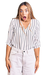 Fototapeta premium Young beautiful blonde woman wearing casual clothes scared and amazed with open mouth for surprise, disbelief face