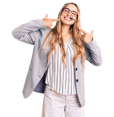 Young beautiful blonde woman wearing call center agent headset smiling cheerful showing and...