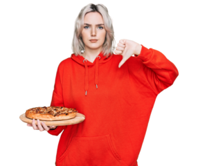 Young blonde girl holding italian pizza with angry face, negative sign showing dislike with thumbs down, rejection concept