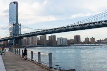 Empire Fulton Ferry promenade area in Brooklyn Bridge Park. Located between the historic Manhattan and Brooklyn Bridges. Seen here is the Manhattan Bridge. 
