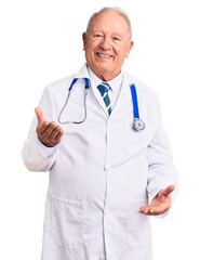 Senior handsome grey-haired man wearing doctor coat and stethoscope smiling cheerful with open arms as friendly welcome, positive and confident greetings