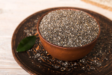 Chia seeds in bowl on colored background. Healthy Salvia hispanica in small bowl. Healthy superfood