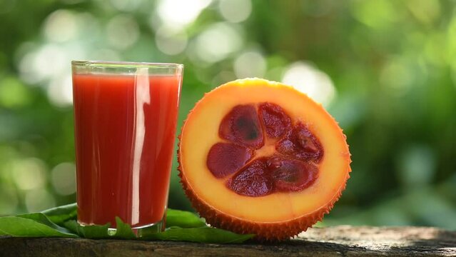 Gac fruits and juice on nature background.