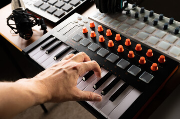 Studio equipment for recording studio, music studio. Musician's hand on midi keyboard. Studio...
