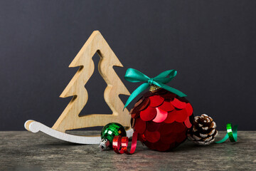 Christmas ball with decorative wooden tree on colored background. decoration bauble with ribbon bow with copy space