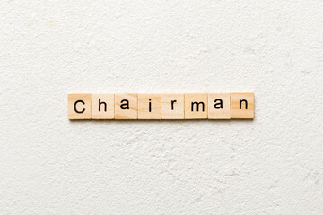 CHAIRMAN word written on wood block. CHAIRMAN text on cement table for your desing, concept