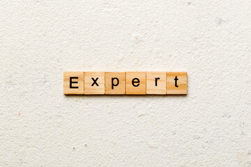 expert word written on wood block. expert text on table, concept