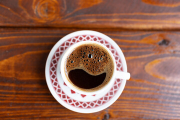 top view of cup of coffee on wooden table