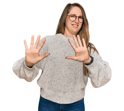 Young blonde woman wearing casual sweater and glasses afraid and terrified with fear expression stop gesture with hands, shouting in shock. panic concept.