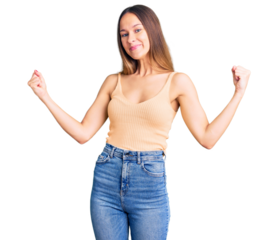 Beautiful brunette young woman wearing casual clothes very happy and excited doing winner gesture with arms raised, smiling and screaming for success. celebration concept.