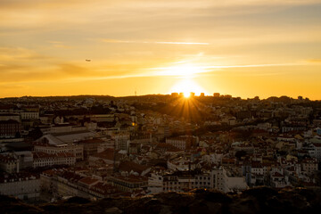 Lisbon city old town landscape during sunset. Golden hour in Lisbon with a view of red rooftops, blue sky and the April 25 Bridge in a distance, view of Lisbon from S&atilde;o Jorge Castle