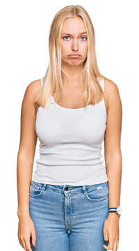 Young blonde girl wearing casual style with sleeveless shirt depressed and worry for distress, crying angry and afraid. sad expression.