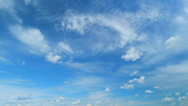 Clouds move lower and faster in the wind. Beautiful colourful fluffy clouds. Timelapse.
