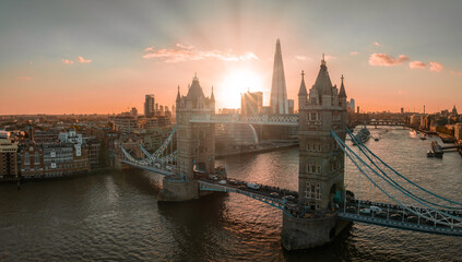 Naklejka premium Aerial view of the London Tower Bridge at sunset. Sunset with beautiful clouds over London - the capital of Britain.
