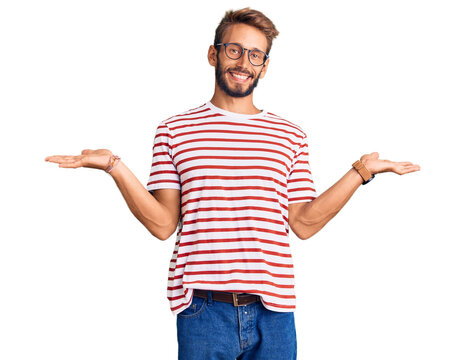Handsome blond man with beard wearing casual clothes and glasses smiling showing both hands open palms, presenting and advertising comparison and balance