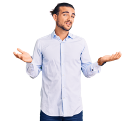 Young handsome man wearing business clothes clueless and confused with open arms, no idea concept.