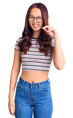 Fototapeta premium Young beautiful chinese girl wearing casual clothes pointing finger up with successful idea. exited and happy. number one.