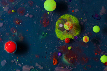 Colorful art, green bubbles exploding in dark liquid. Abstract art.