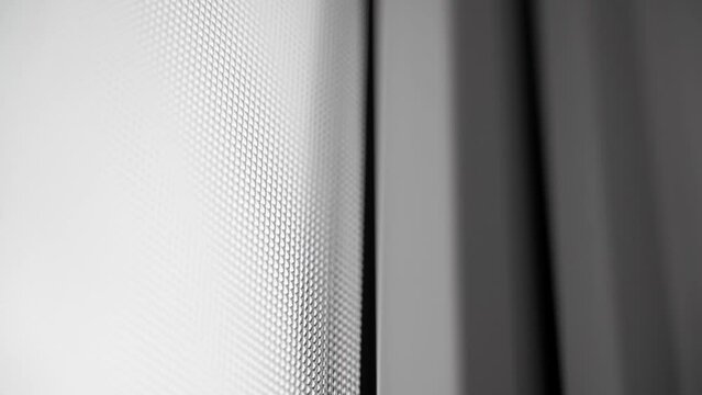 Double-glazed window of a plastic door with opaque glass close-up in the dark. Textured window in a plastic case. Smooth camera movement. White front doors