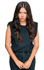 Fototapeta premium Beautiful brunette young woman wearing black shirt skeptic and nervous, frowning upset because of problem. negative person.