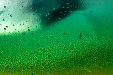 Green background with shiny, reflective, and shadow areas.