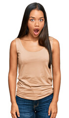 Fototapeta premium Beautiful hispanic woman wearing casual clothes afraid and shocked with surprise expression, fear and excited face.