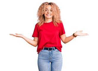 Young blonde woman with curly hair wearing casual red tshirt smiling showing both hands open palms, presenting and advertising comparison and balance