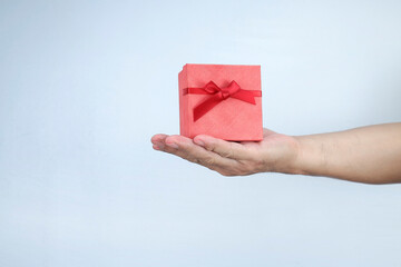 A red gift box on the palm 
