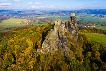 Fototapeta na wymiar Aerial view of two towers of ruined abandoned Trosky Castle on tops of stone rocks domineering over Czech nature reserve 