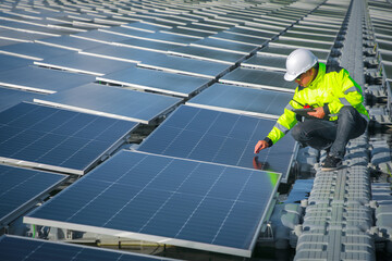 Portrait of professional man engineer working checking the panels at solar energy on buoy floating. Power plant with water, renewable energy source. Eco technology for electric power in industry.