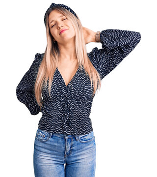 Young beautiful blonde woman wearing casual clothes suffering of neck ache injury, touching neck with hand, muscular pain