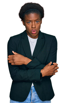 Young african american girl wearing business clothes shaking and freezing for winter cold with sad and shock expression on face