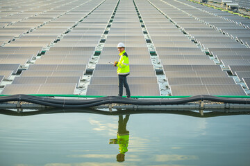 Portrait of professional man engineer working checking the panels at solar energy on buoy floating....