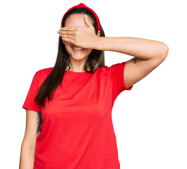 Young hispanic woman wearing casual clothes smiling and laughing with hand on face covering eyes for surprise. blind concept.