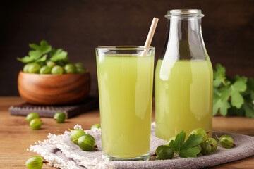 Tasty gooseberry juice on wooden table, closeup