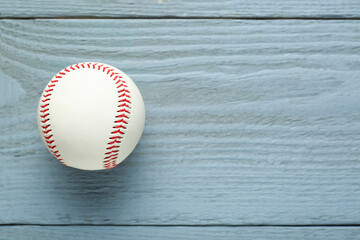 Baseball ball on grey wooden table, top view. Space for text