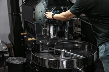 Man near coffee roaster machine indoors, closeup