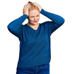 Young blonde woman wearing casual clothes suffering from headache desperate and stressed because pain and migraine. hands on head.