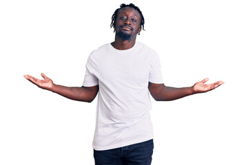 Young african american man with braids wearing casual white tshirt smiling showing both hands open palms, presenting and advertising comparison and balance