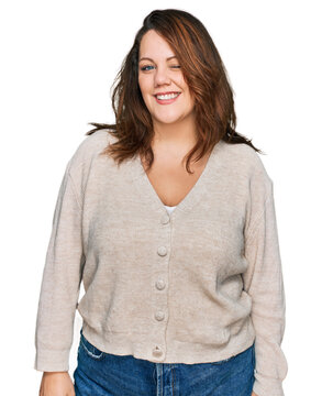 Young plus size woman wearing casual clothes winking looking at the camera with sexy expression, cheerful and happy face.