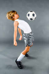 Child Boy Soccer Player Bouncing Soccer Ball Off His Chest