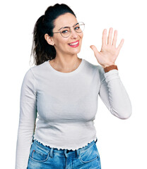 Young hispanic woman wearing casual clothes showing and pointing up with fingers number five while smiling confident and happy.