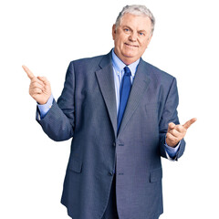 Senior grey-haired man wearing business jacket smiling confident pointing with fingers to different directions. copy space for advertisement