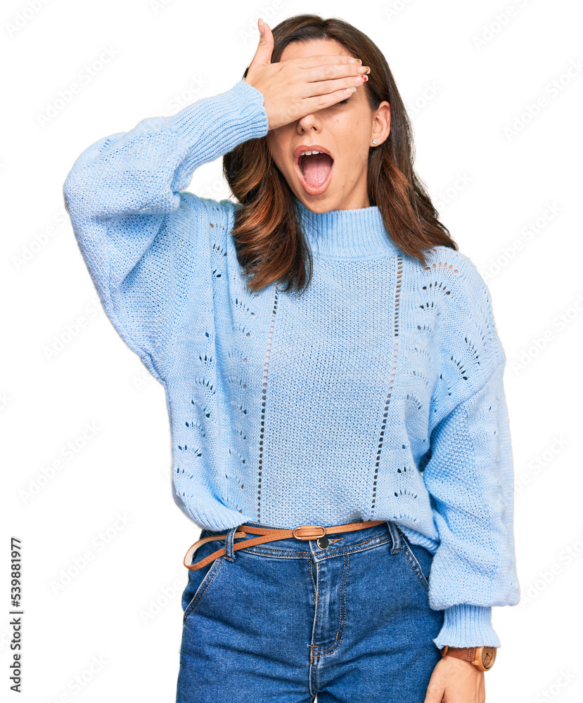 Poster Young brunette woman wearing casual winter sweater smiling and laughing with hand on face covering eyes for surprise. blind concept.