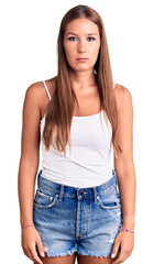 Obraz premium Young beautiful hispanic woman wearing casual clothes with serious expression on face. simple and natural looking at the camera.