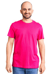 Fototapeta premium Young handsome man wearing casual t shirt with a happy and cool smile on face. lucky person.