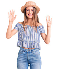 Young beautiful girl wearing hat and t shirt showing and pointing up with fingers number nine while smiling confident and happy.