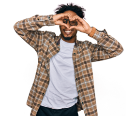 Young african american man with beard wearing casual clothes and glasses doing heart shape with hand and fingers smiling looking through sign